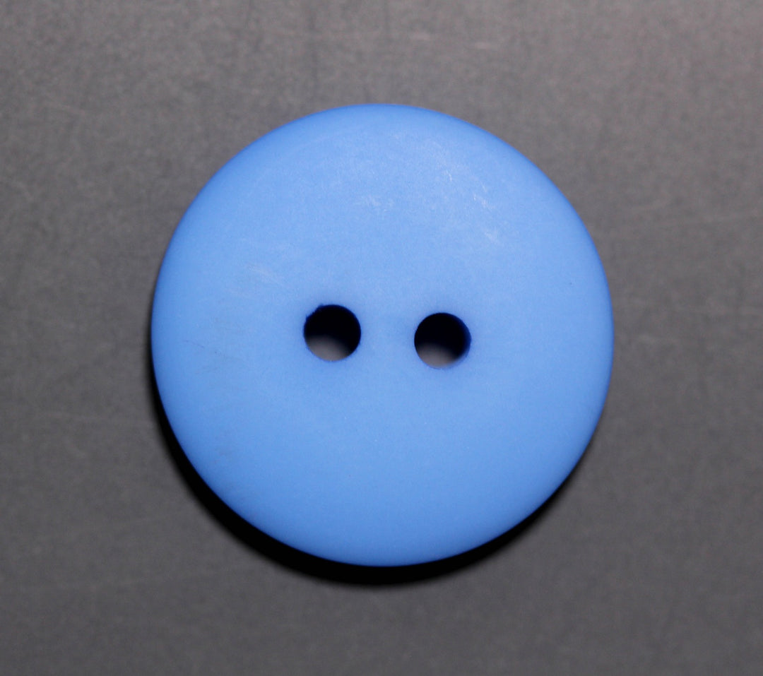 Blue button with two holes on a gray background