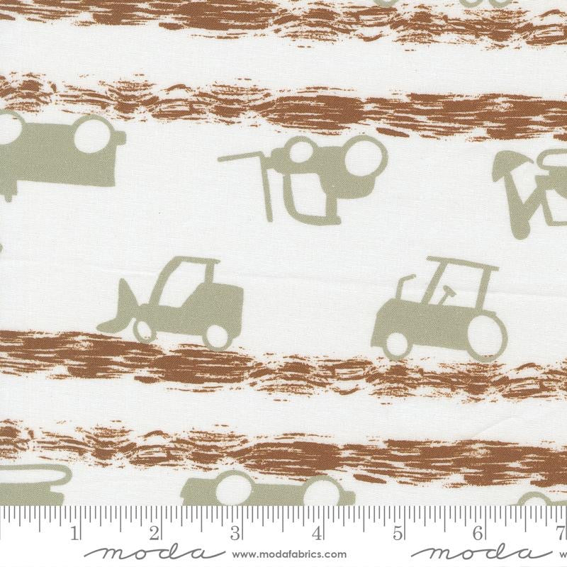 Fabric pattern with tractor designs on a striped background, featuring the Moda label.