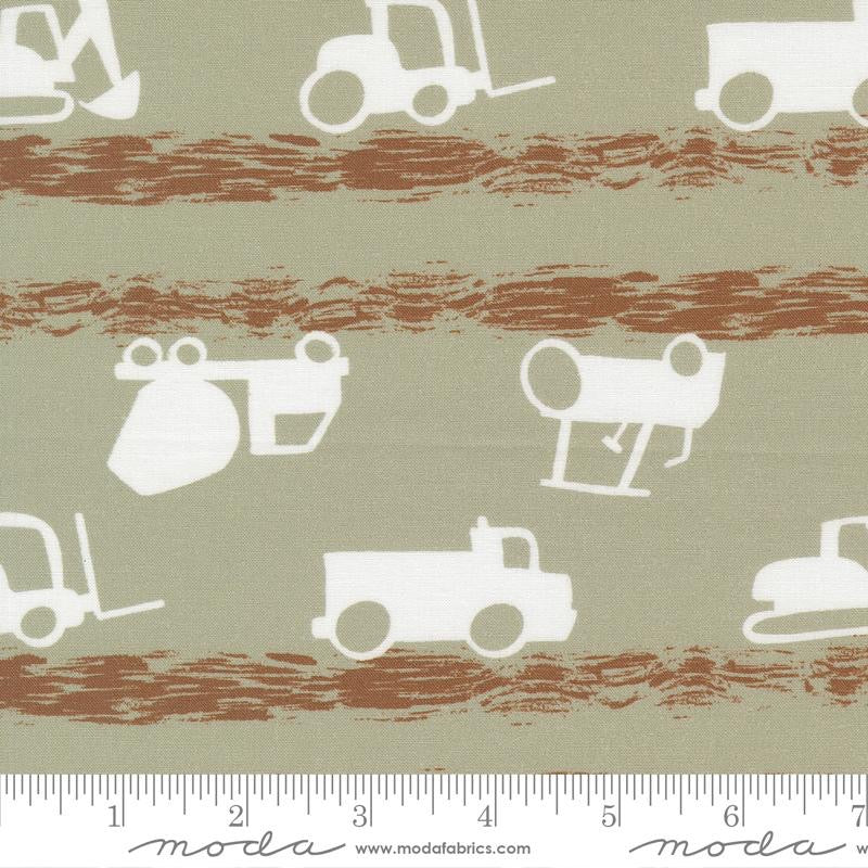 Fabric pattern with construction vehicle icons on a striped background, featuring Moda label.