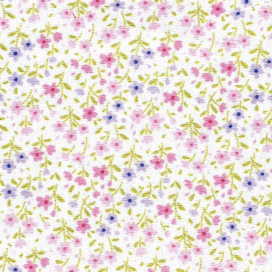 Floral pattern with small pink and purple flowers on a white background