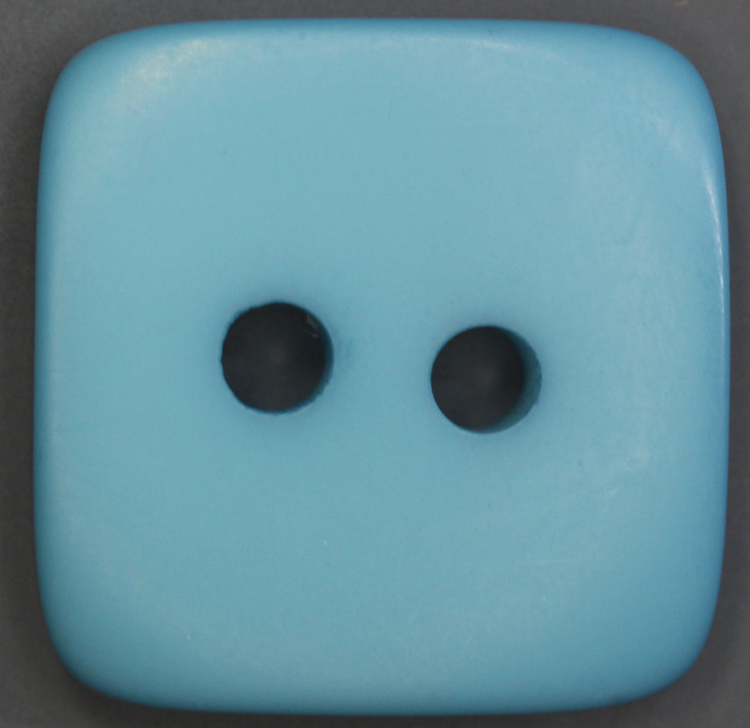 Blue square object with two black dots on a dark background