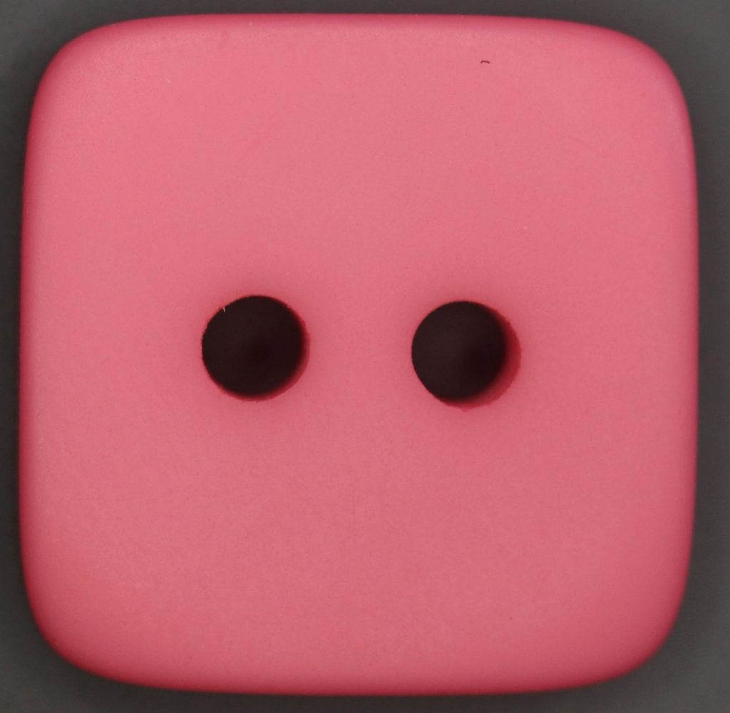 Pink square button on a dark background