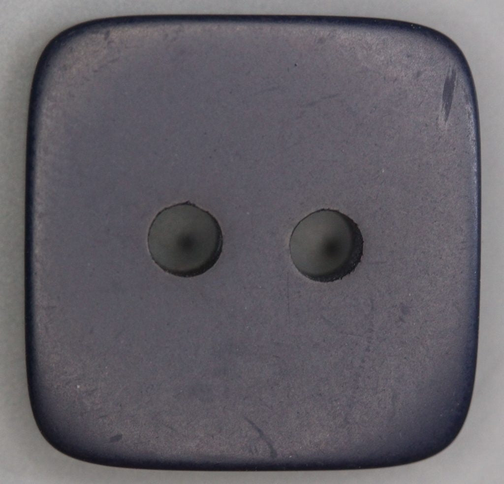 Dark navy square two hole button on a light gray background
