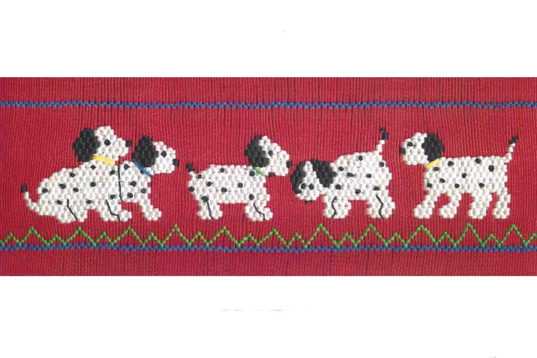 A close-up of a red pleated insert featuring a row of white Dalmatian dogs with black spots, bordered by blue and green zigzag lines.