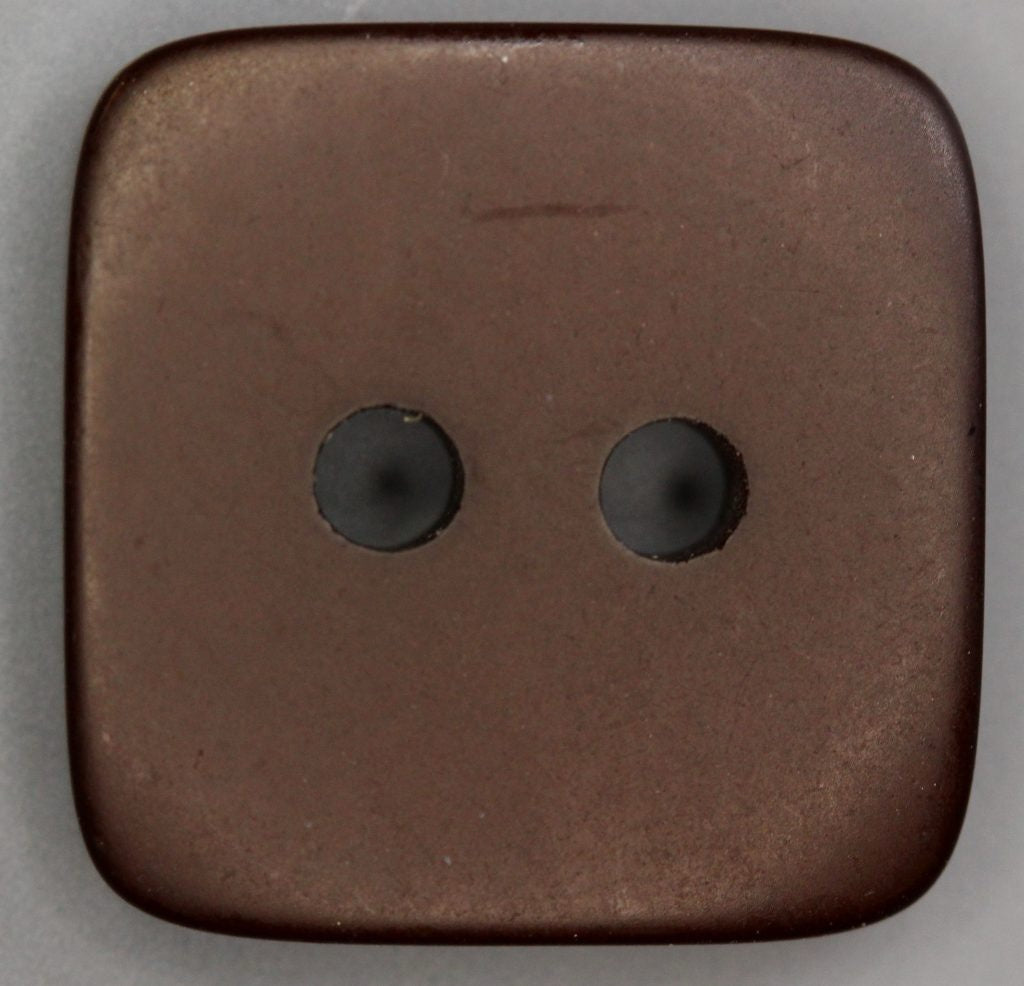 Brown square button with two holes on a gray background