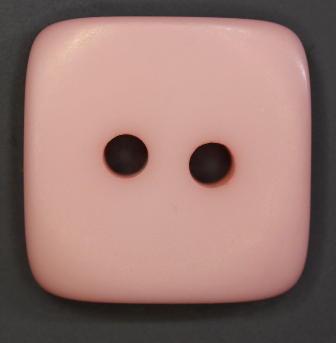 Pink square button on a dark background