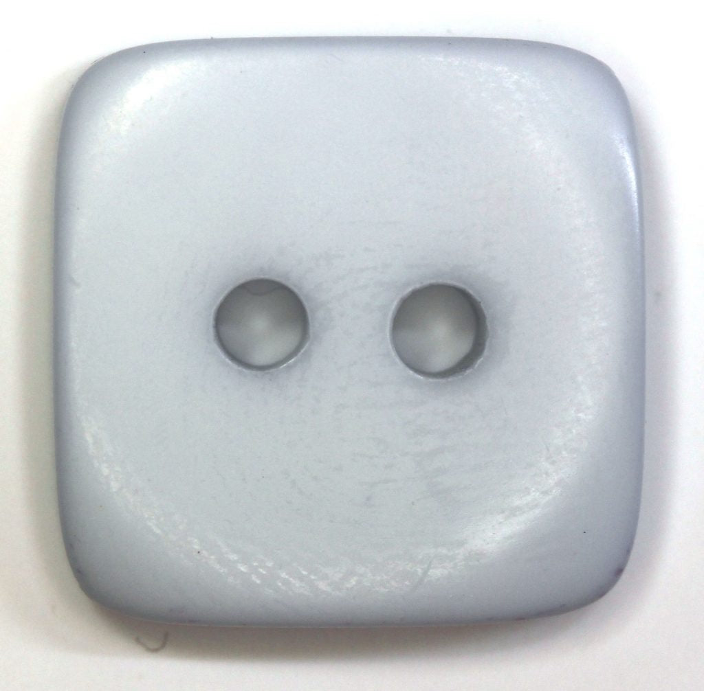 Pastel blue square button with two holes on a white background