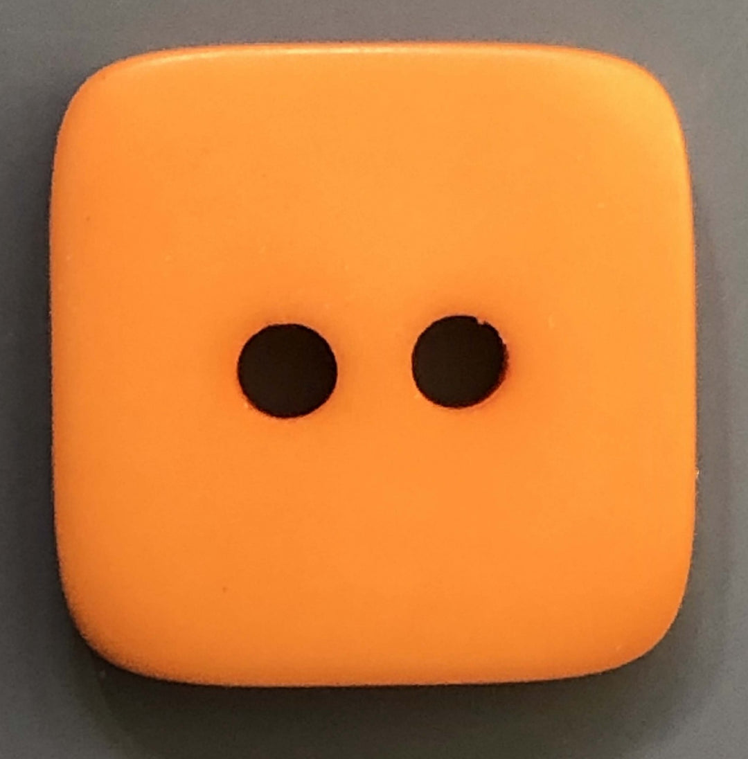 pumpkin colored square 2 hole button on a dark background