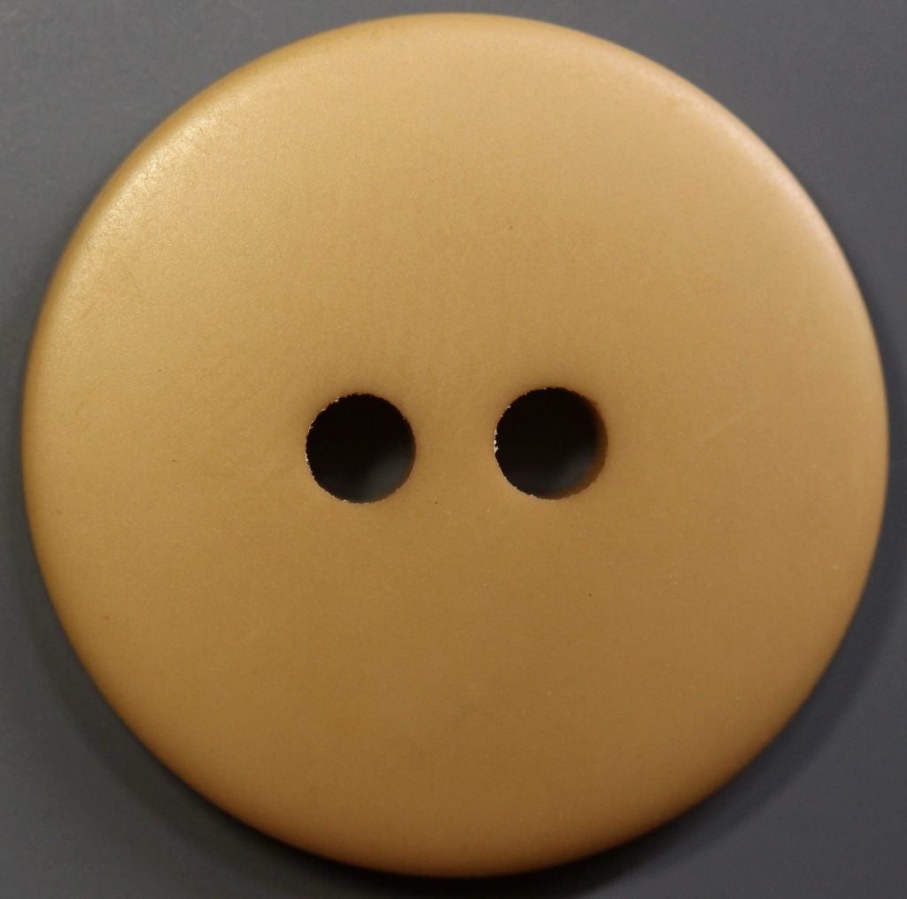 round 2 hole khaki button on a dark background