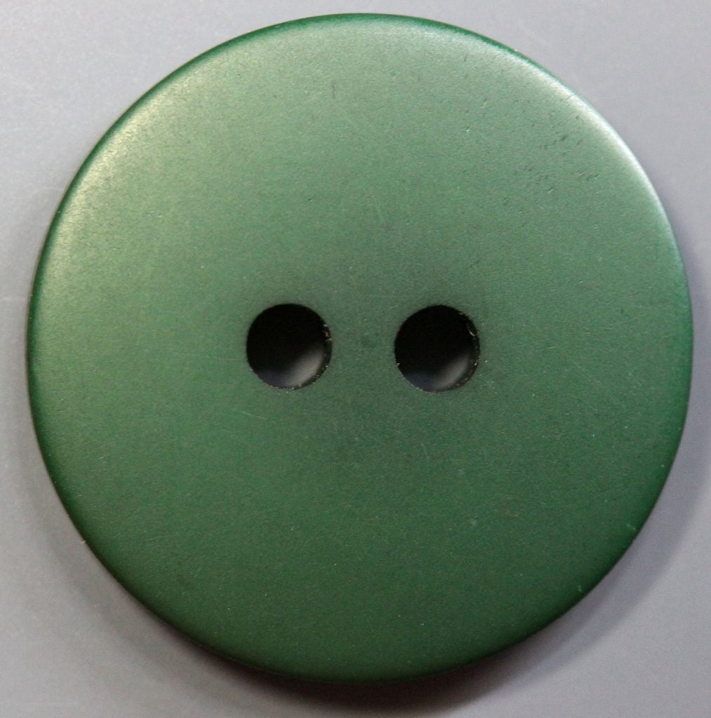 Green button with two holes on a light gray background
