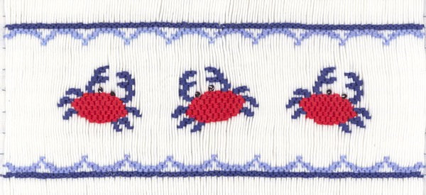 Smocking plate with three crabs. 8 rows of smocking on a yoke.