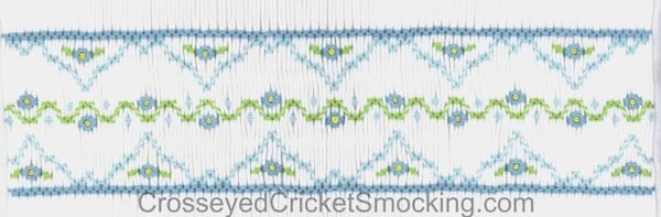 Smocking plate with floral design. 6 rows on a yoke.