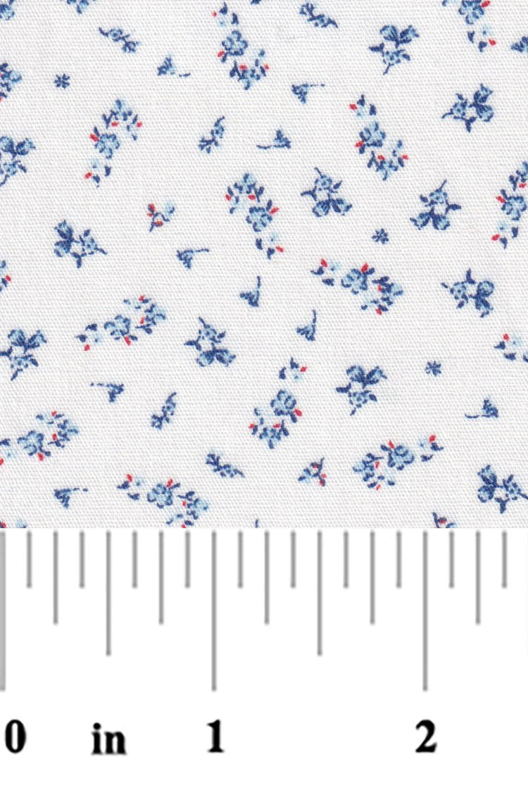 Floral patterned fabric with a ruler at the bottom for scale on a white background