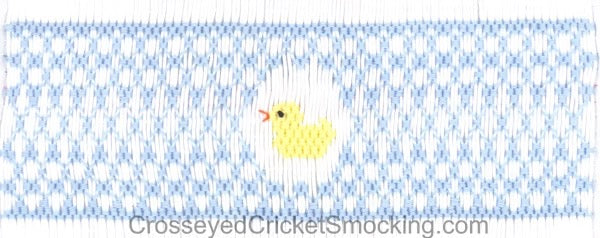 blue smocking surrounding a yellow smocked duck on a pleated insert