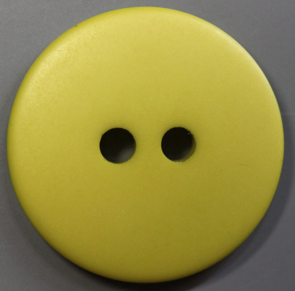 Olive button with two holes on a gray background