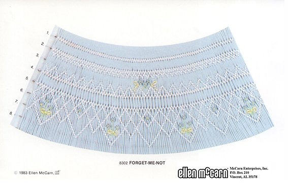 geometric smocking design smocked in whit blue and yellow on blue pleated fabric