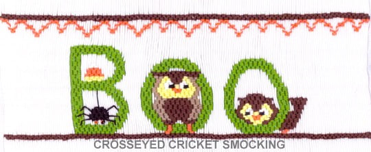 Smocking plate with Boo spelled out with a spider, candy corn and some owls. 8 rows of smocking on a yoke.