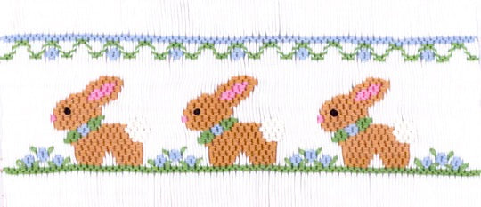 Smocking plate with three bunnies among some flowers. 8 1/2 rows of smocking on a yoke.