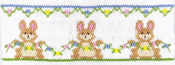 Bunnies holding a floral garland. 7 1/2 rows or 162 Pleats on a yoke.