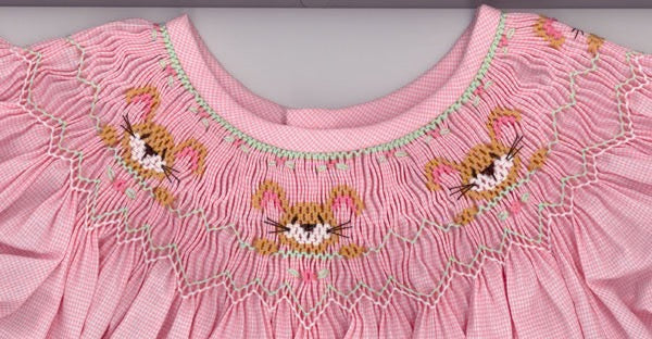 Smocking plate with three bunnies along with geometric designs. 7 rows of smocking on a bishop.