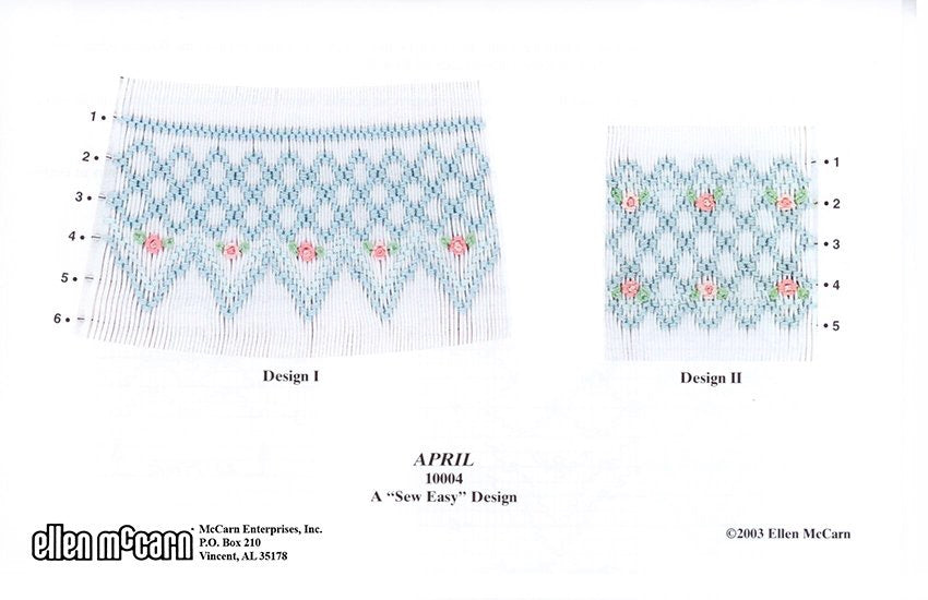 smocking in blues and light and medium pink accented with green leaves on white pleated fabric