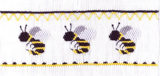 Smocking plate with three bees/yellow jackets. 8 rows of smocking on a yoke.