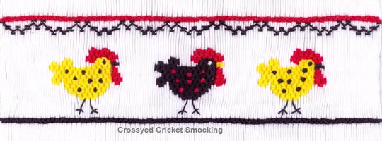 Smocked fabric with three chickens in yellow, black, and red on a white background.