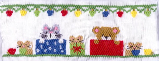 Smocking plate with Christmas gifts with a cat, mice and a bear peeking over the top. 7 rows of smocking on a yoke.