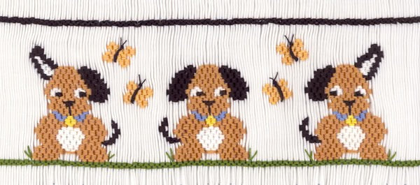 Smocking plate with three dog and butterflies. 8 rows of smocking on a yoke.