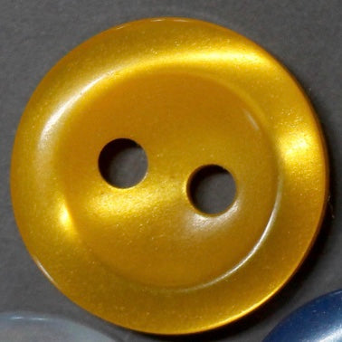 Gold button with two holes on a gray background