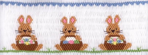 Smocking plate with three bunnies each holding a basket of eggs. 8 rows of smocking on a yoke.
