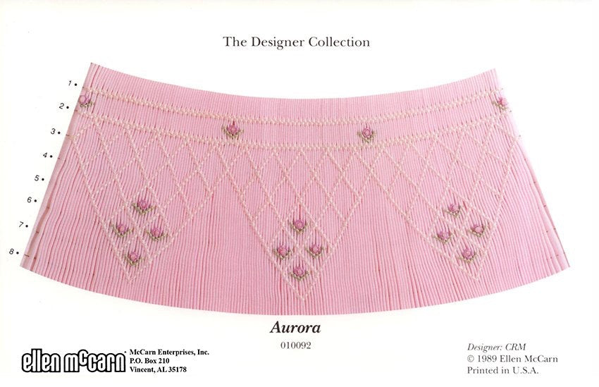 pink pleated fabric smocked in pink with darker pink roses and green leaves