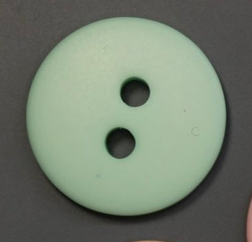 A pastel green polyester button with two holes
