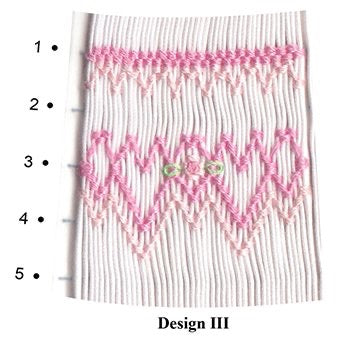 geometric smocking design smocked in pink and green on white pleated fabric
