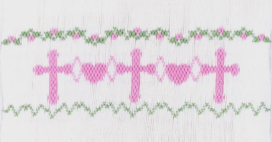 Smocking plate with crosses and hearts. 8 rows of smocking on a yoke.