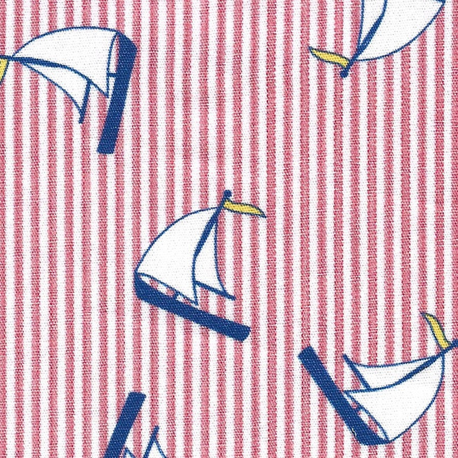 100% cotton print. 60″ wide. This fabric has blue, yellow, and white sailboats on a white and red striped background