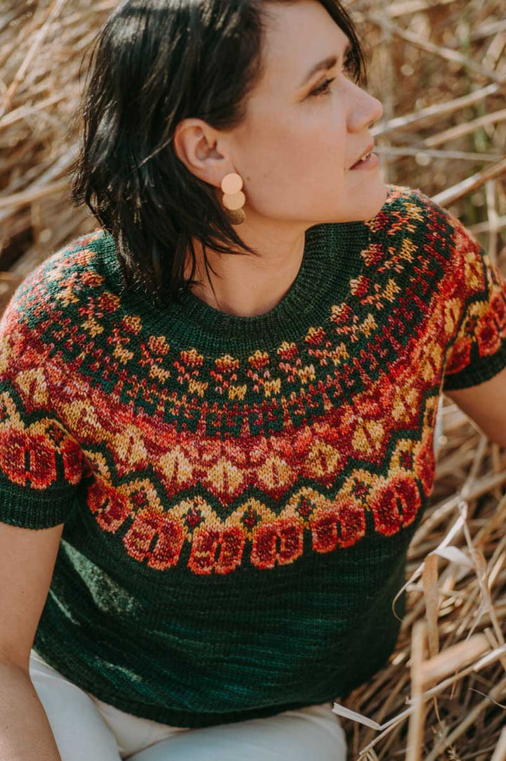 Woman wearing a colorful knitted sweater in a natural setting