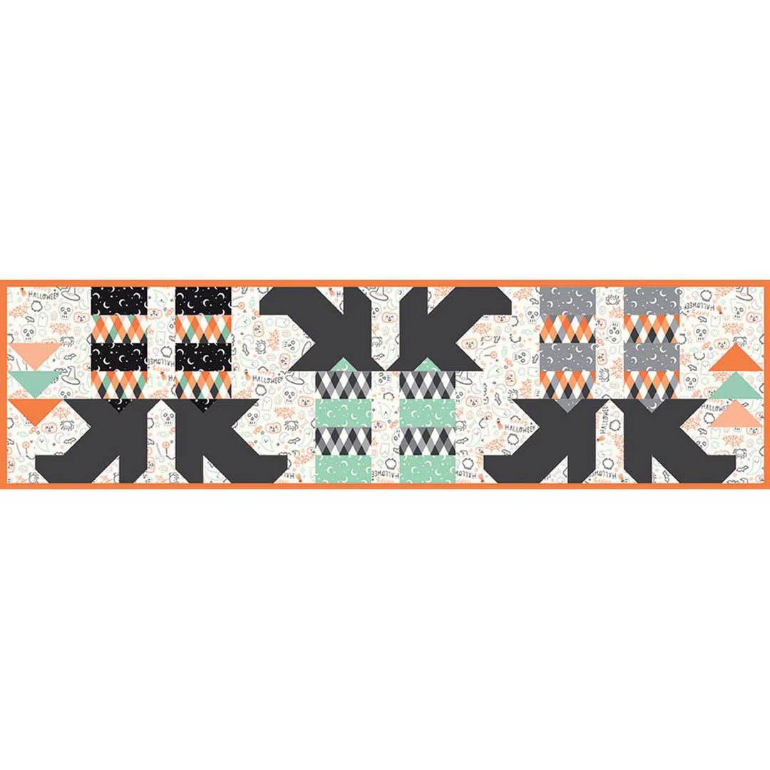 Geometric patterned table runner with black, orange, and gray design on a white background