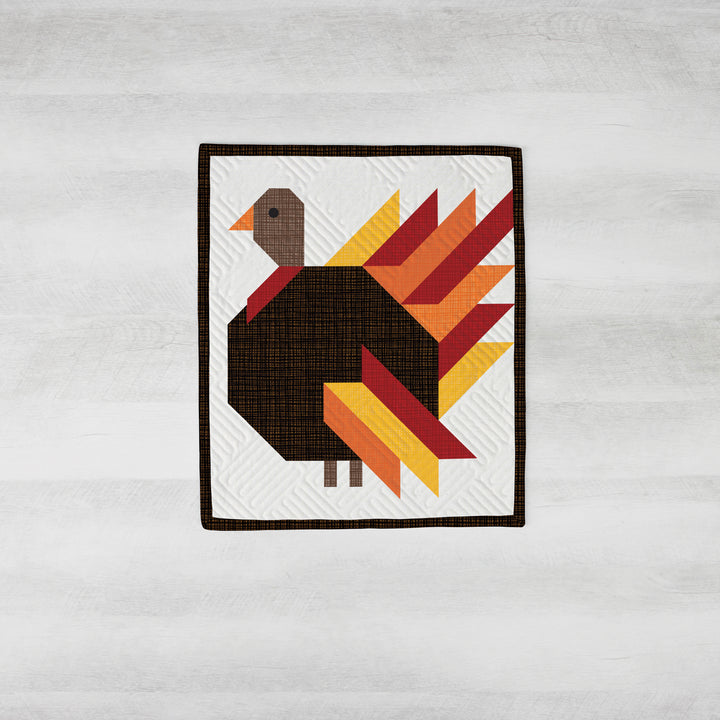 Quilt with a turkey design on a white background