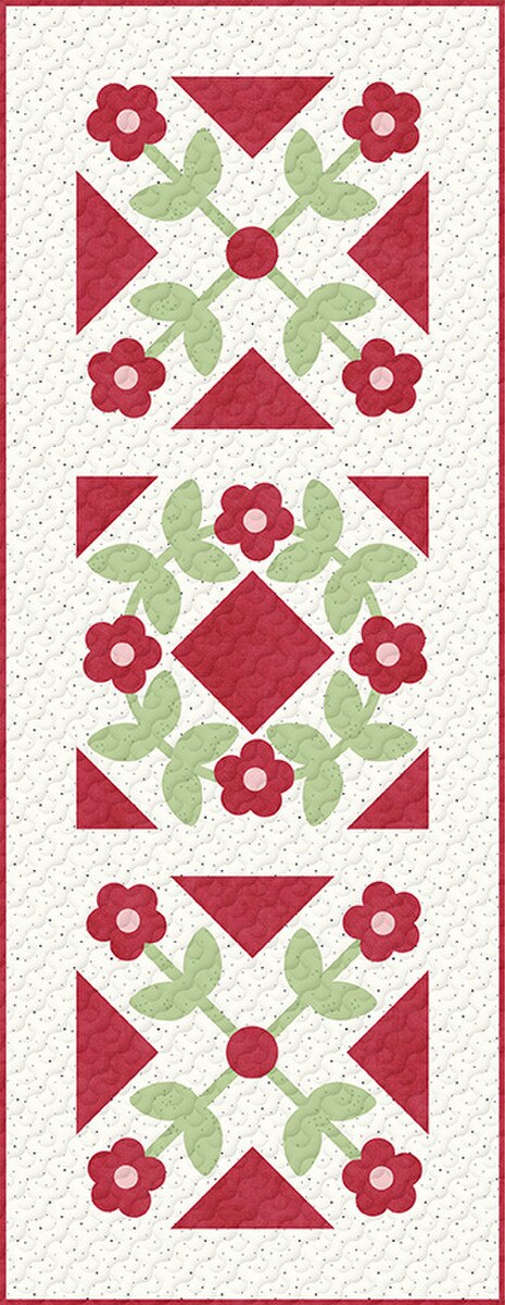 Quilt pattern with red and green geometric shapes on a white background