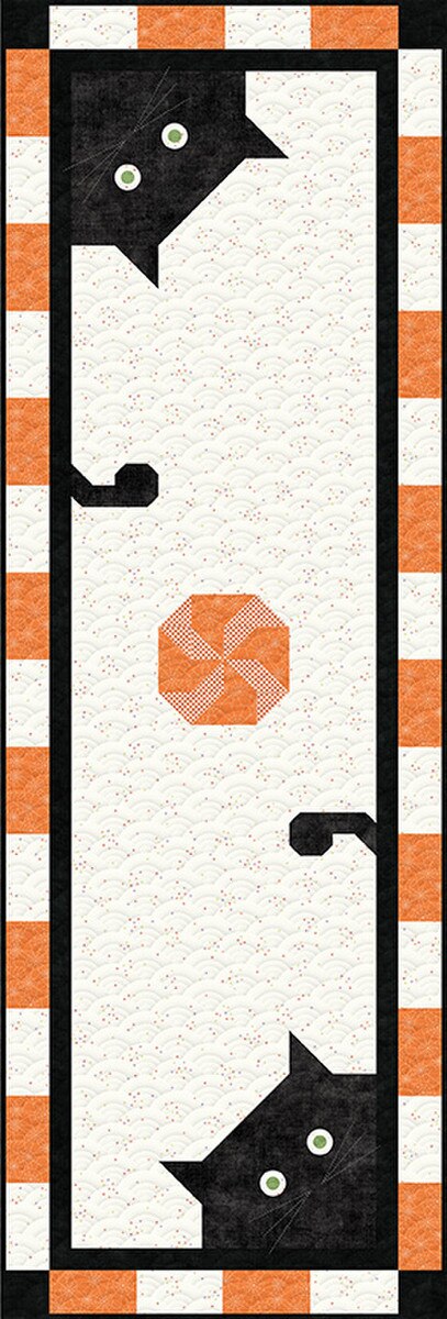 Halloween-themed quilt with black cats, orange hexagons, and striped border.
