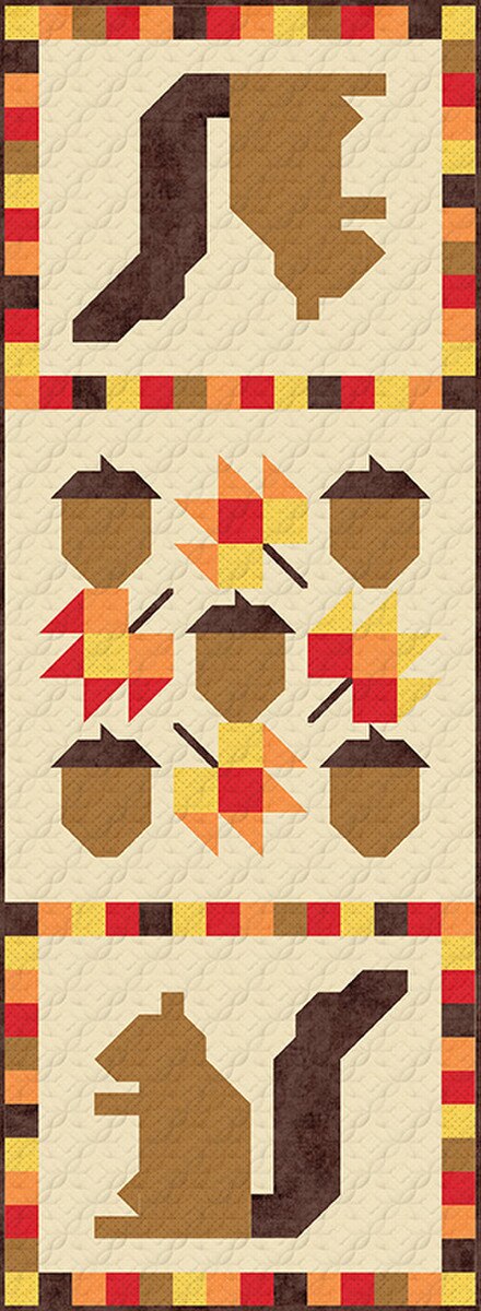 Quilt pattern with autumn-themed shapes including acorns and a squirrel on a beige background.