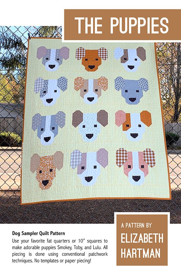 Dog Sampler Quilt Pattern by Elizabeth Hartman with quilt displayed outdoors.