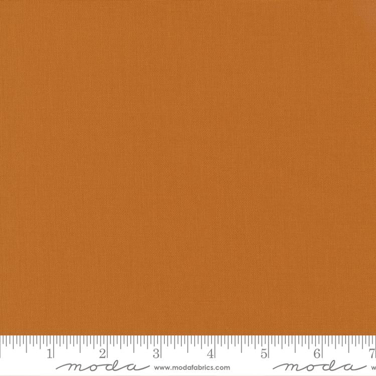 Solid orange fabric swatch with a ruler at the bottom for scale.