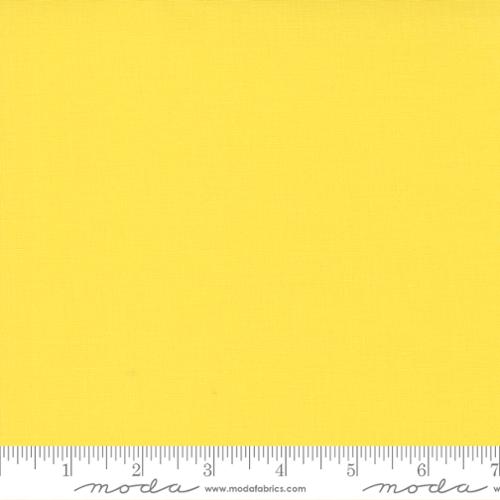Solid yellow fabric swatch with a ruler at the bottom for scale.