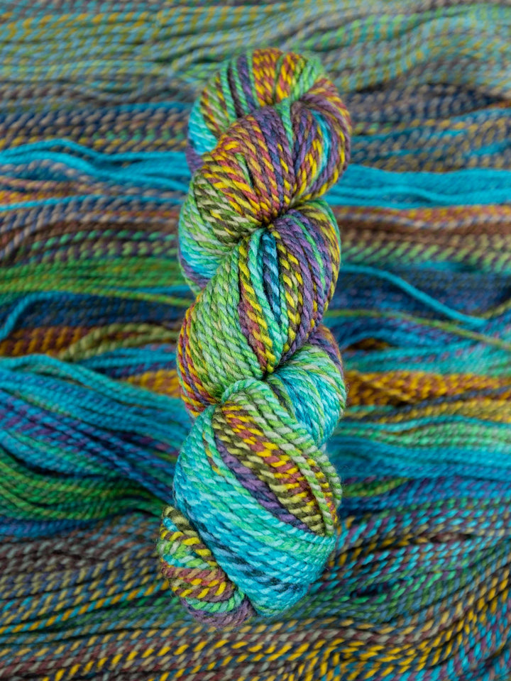 Colorful skein of yarn on a textured fabric background