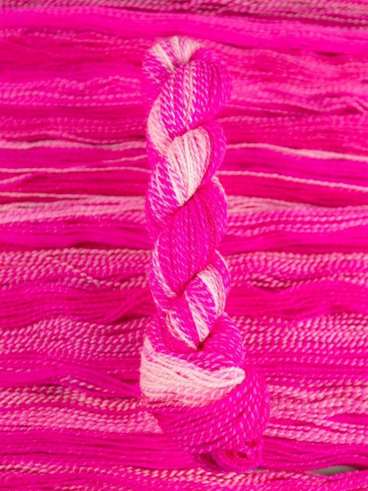 Close-up of pink yarn on a pink background