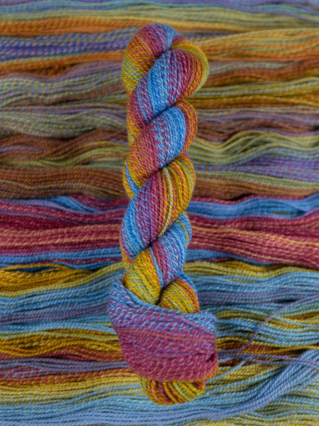 Colorful skein of yarn on a textured multicolored background