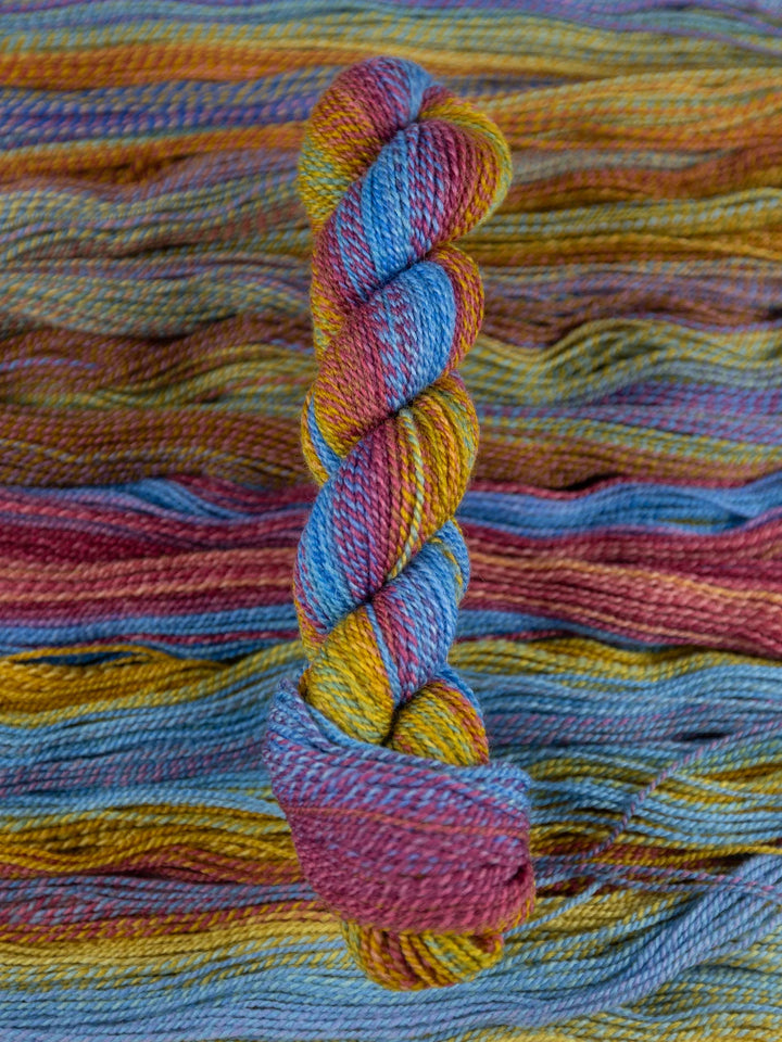 Colorful skein of yarn on a textured multicolored background