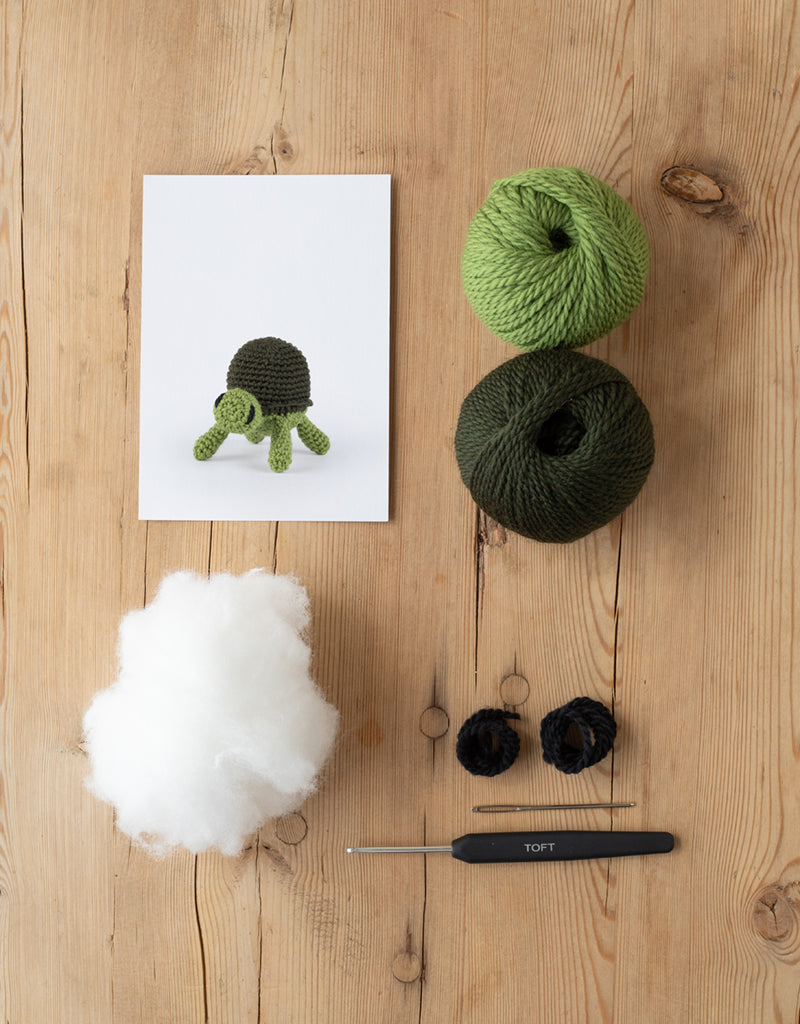 Mini Tortoise kit includes yarn, stuffing, needle, and crochet hook
